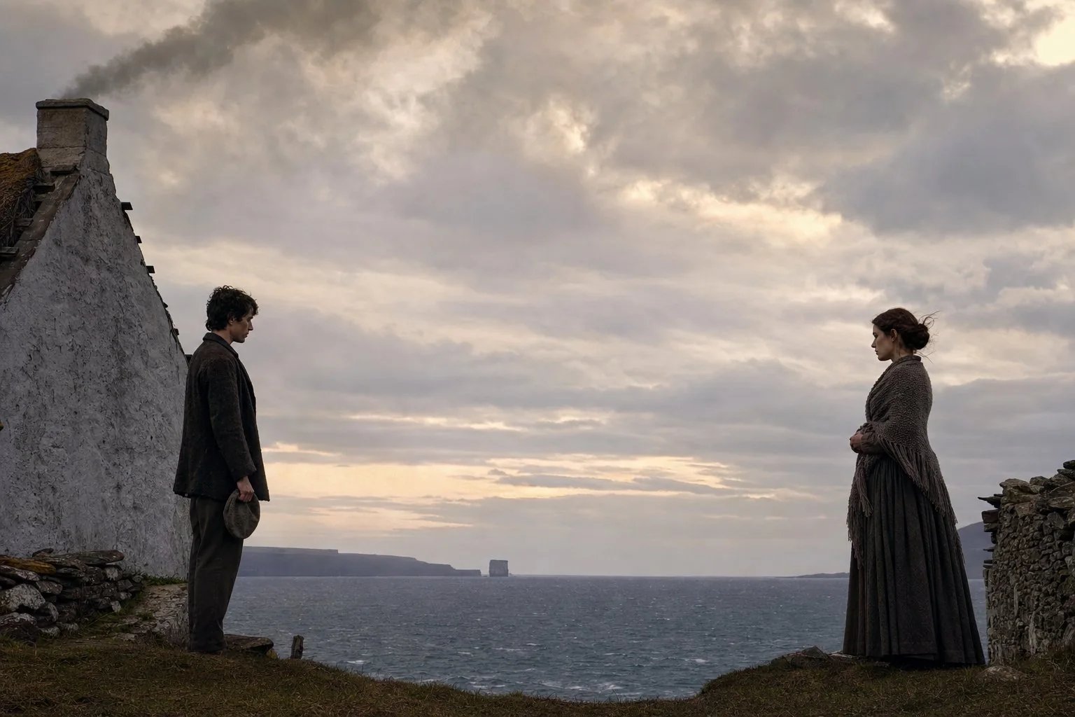 A man with his cap in his hand and a woman in a shawl stand a pace apart at the gable of a cottage, open sea between them at evening.